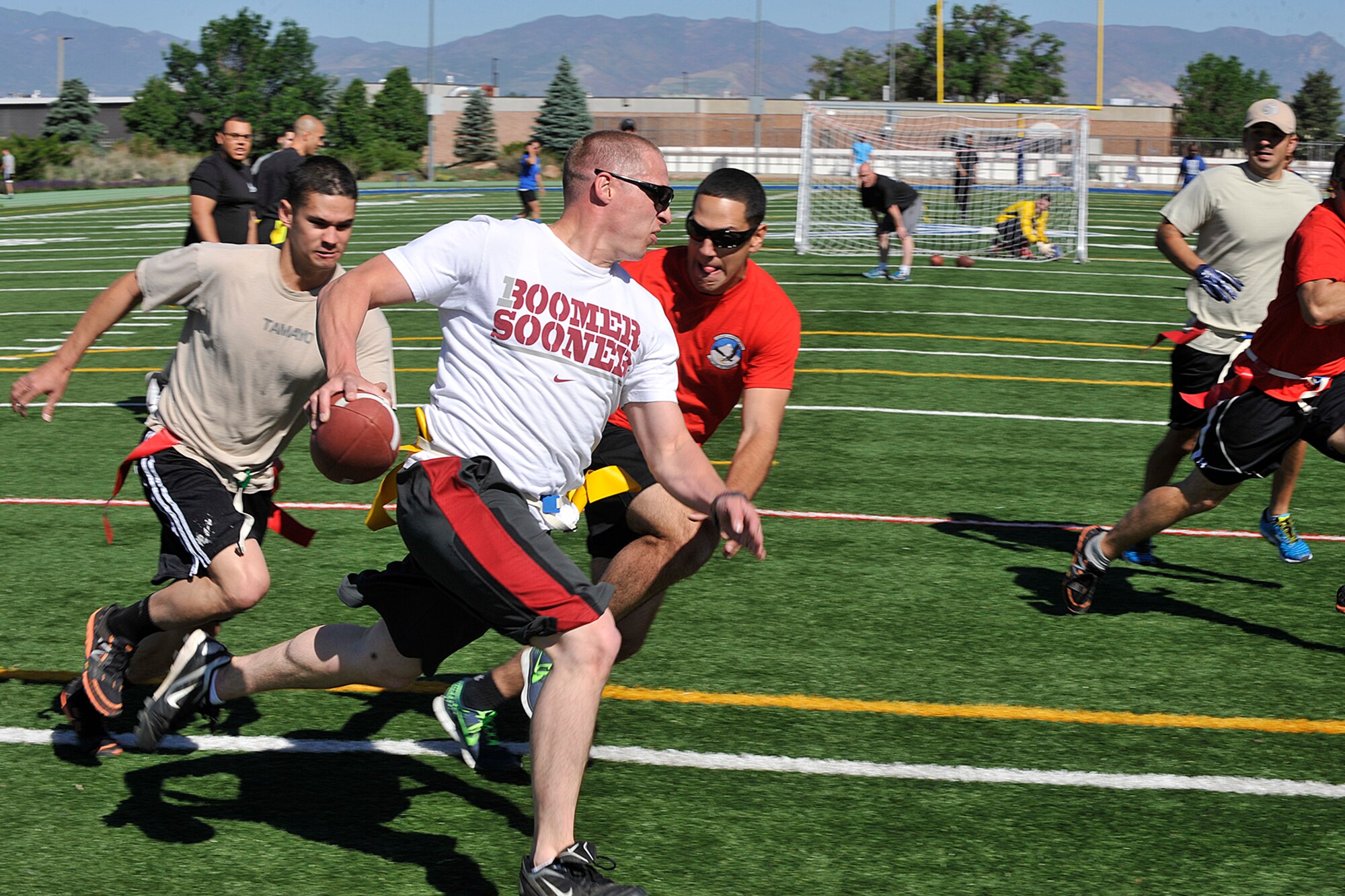 PETERSON AIR FORCE BASE, Colo. – Flag football was one of more than 30 events during Team Pete’s 2014 sports and field day June 19 here. Thousands participated in several events ranging from Texas Hold’em and bowling to cycling and tug-of-war. (U.S. Air Force photo/Dennis Howk)