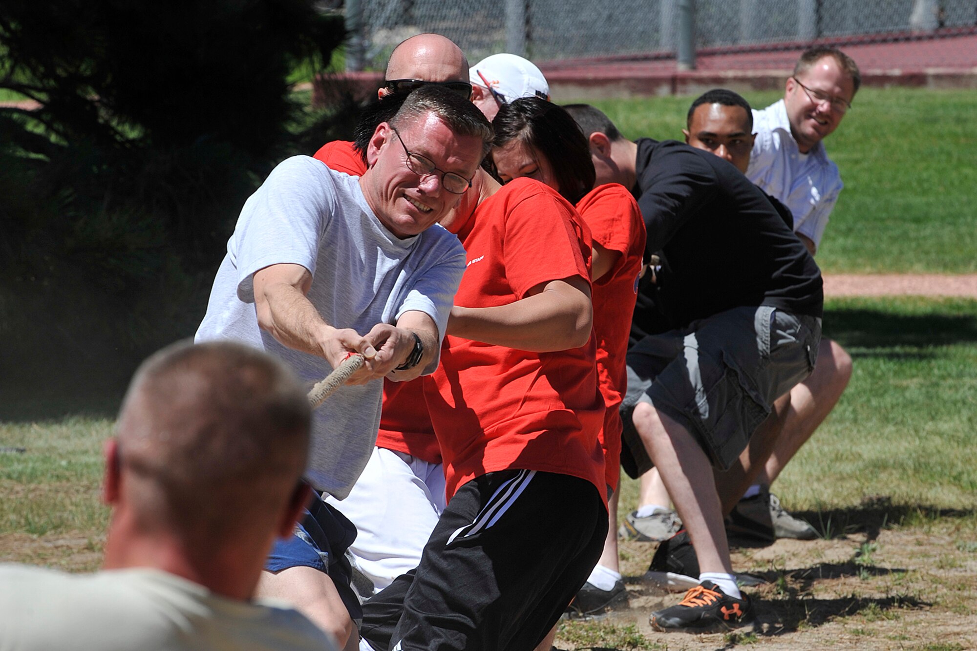 PETERSON AIR FORCE BASE, Colo. – Col. Reginald Ash III, 21st Mission Support Group commander, and the 21st MSG tug-of-war team struggle against their opponents June 19 here. Tug-of-war was one of more than 30 events held at Team Pete’s 2014 sports and field day. (U.S. Air Force photo/Dennis Howk)