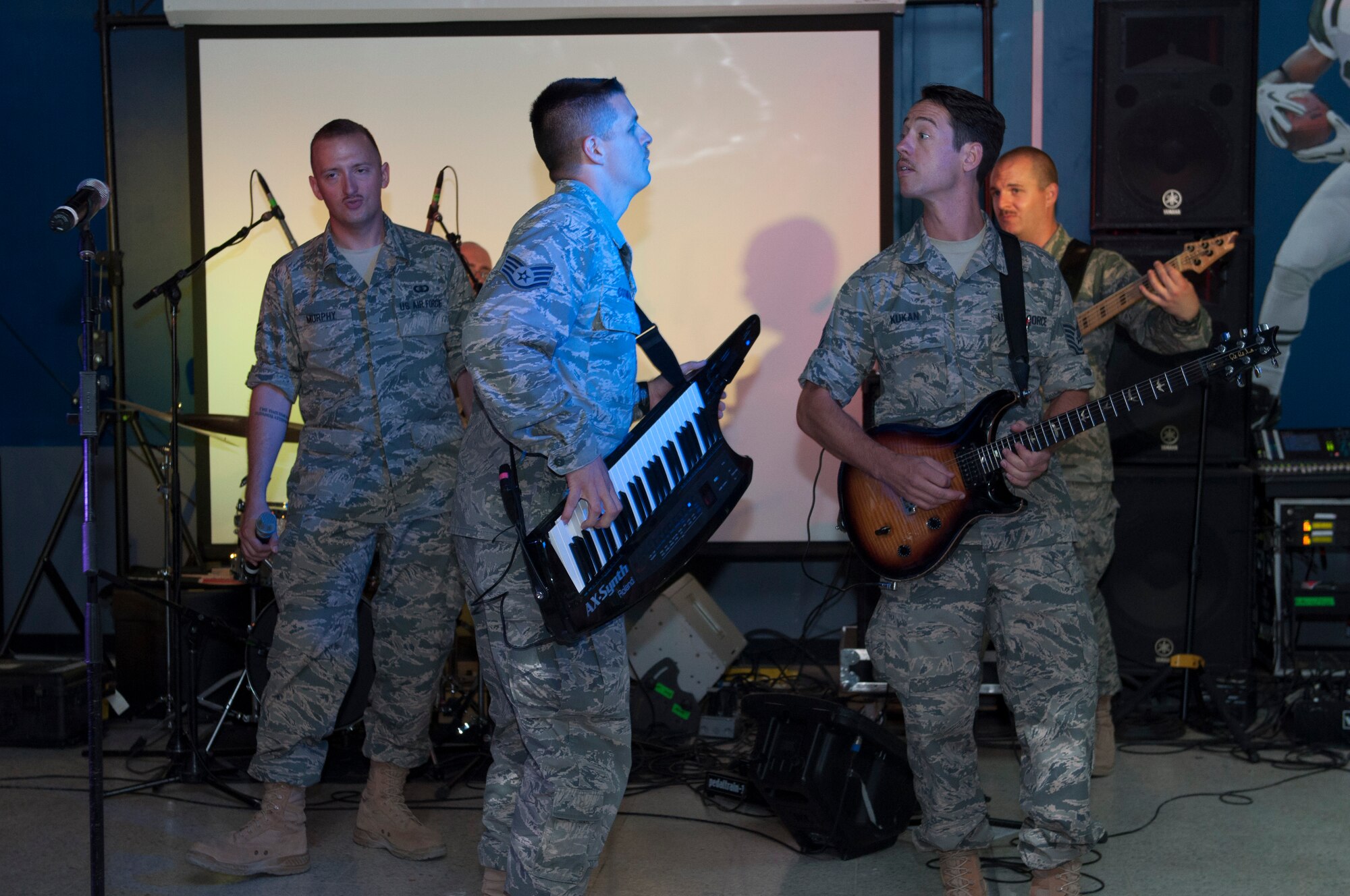 Staff Sgt. Chip Cothran, piano player and Tech. Sgt. Johnny Kukan, lead guitarist engages in a friendly challenge trying to best each other while playing. Starlifter is a seven-member group of talented musicians that performs in virtually every musical idiom and was here in support of Operation Enduring Freedom. (U.S. Air Force photo by Senior Master Sgt. Allison Day)