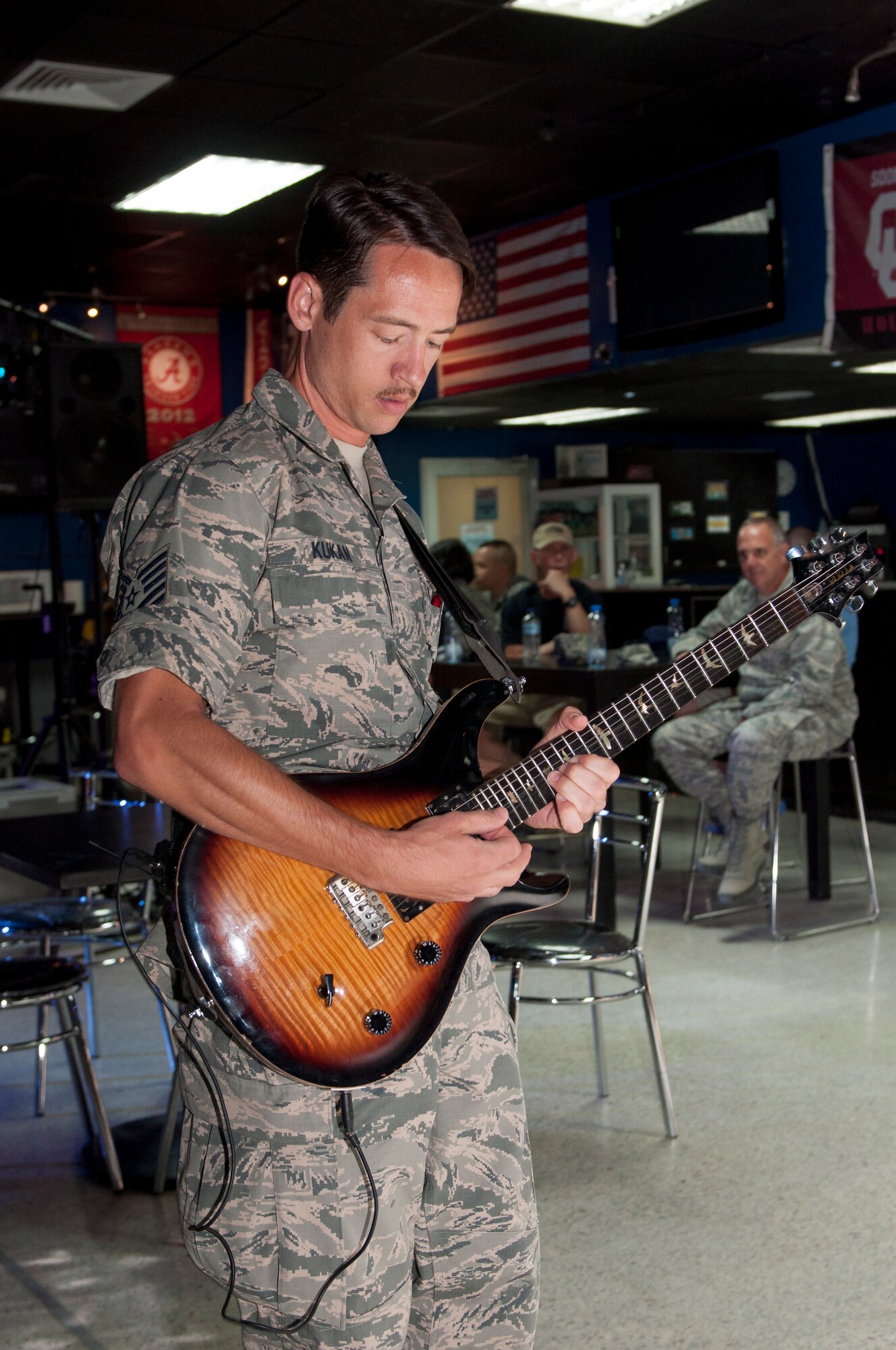 Tech. Sgt. Johnny Kukan, lead guitarist with Starrlifter, plays at the Drop Zone at The Rock June 17, 2014. Starlifter is a seven-member group of talented musicians that performs in virtually every musical idiom and was here in support of Operation Enduring Freedom. (U.S. Air Force photo by Senior Master Sgt. Allison Day)