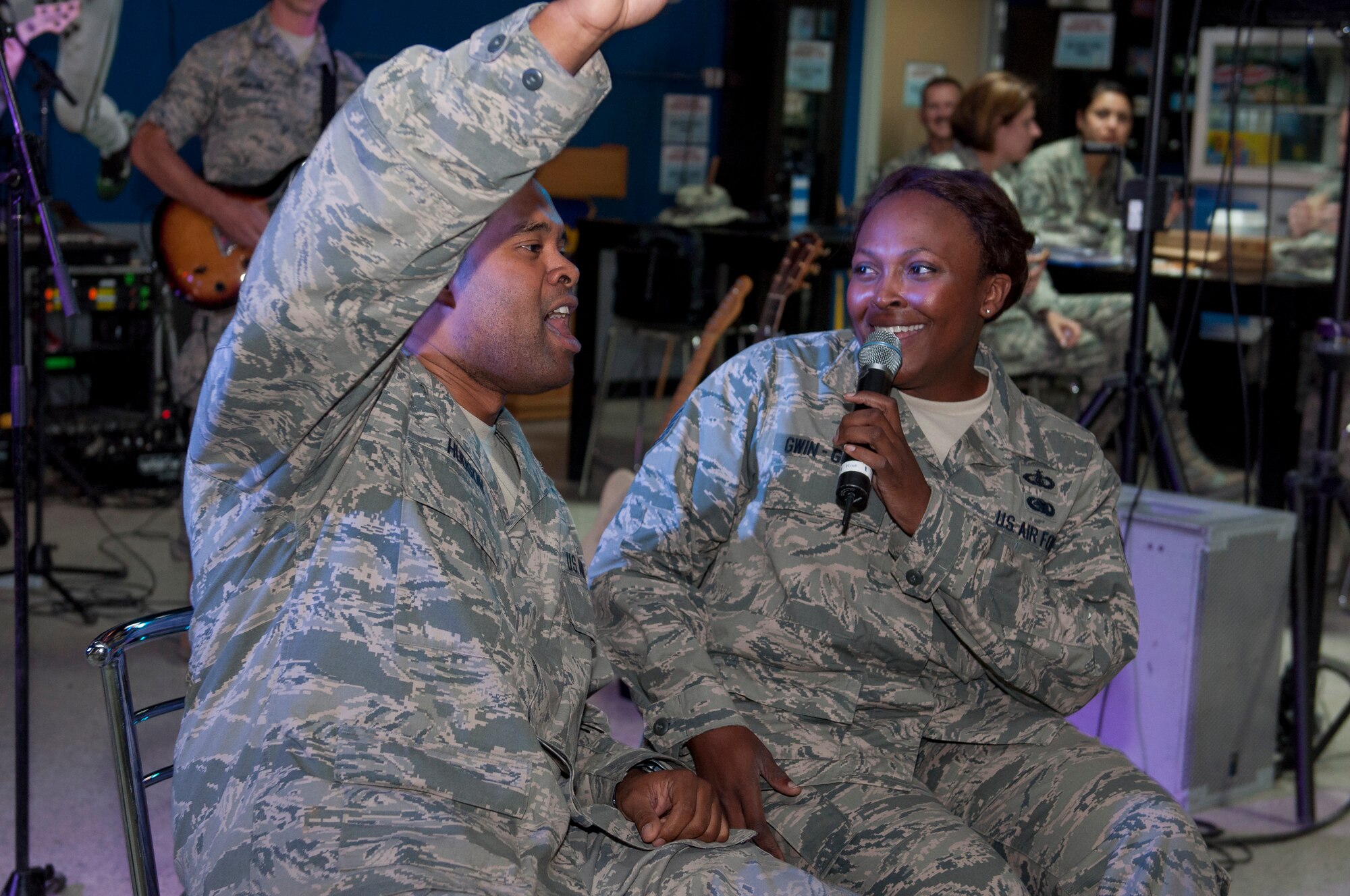 Capt. Matthew Hudson got an opportunity to sing with Tech. Sgt. Keisha Gwin-Goodwin, lead vocalist with Starlifter, during a performance held at The Rock June 17, 2014. Starlifter is a seven-member group of talented musicians that performs in virtually every musical idiom and was here in support of Operation Enduring Freedom. (U.S. Air Force photo by Senior Master Sgt. Allison Day)