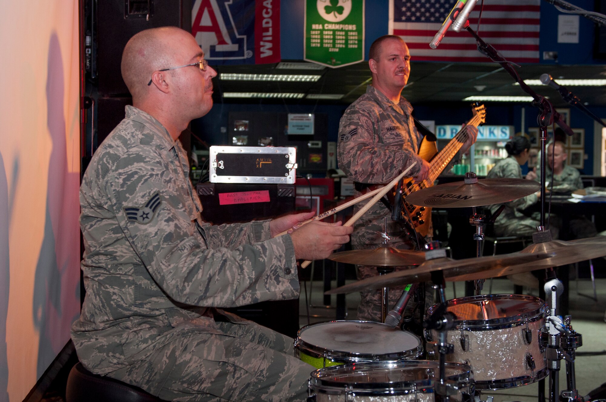 Senior Airmen JonMarc Dale,  Starlifter Drummer, and Chris Haughey, guitarist,  play at the Drop Zone at The Rock June 17, 2014.  Starlifter is a seven-member group of talented musicians that performs in virtually every musical idiom and was here in support of Operation Enduring Freedom. (U.S. Air Force photo by Senior Master Sgt. Allison Day)