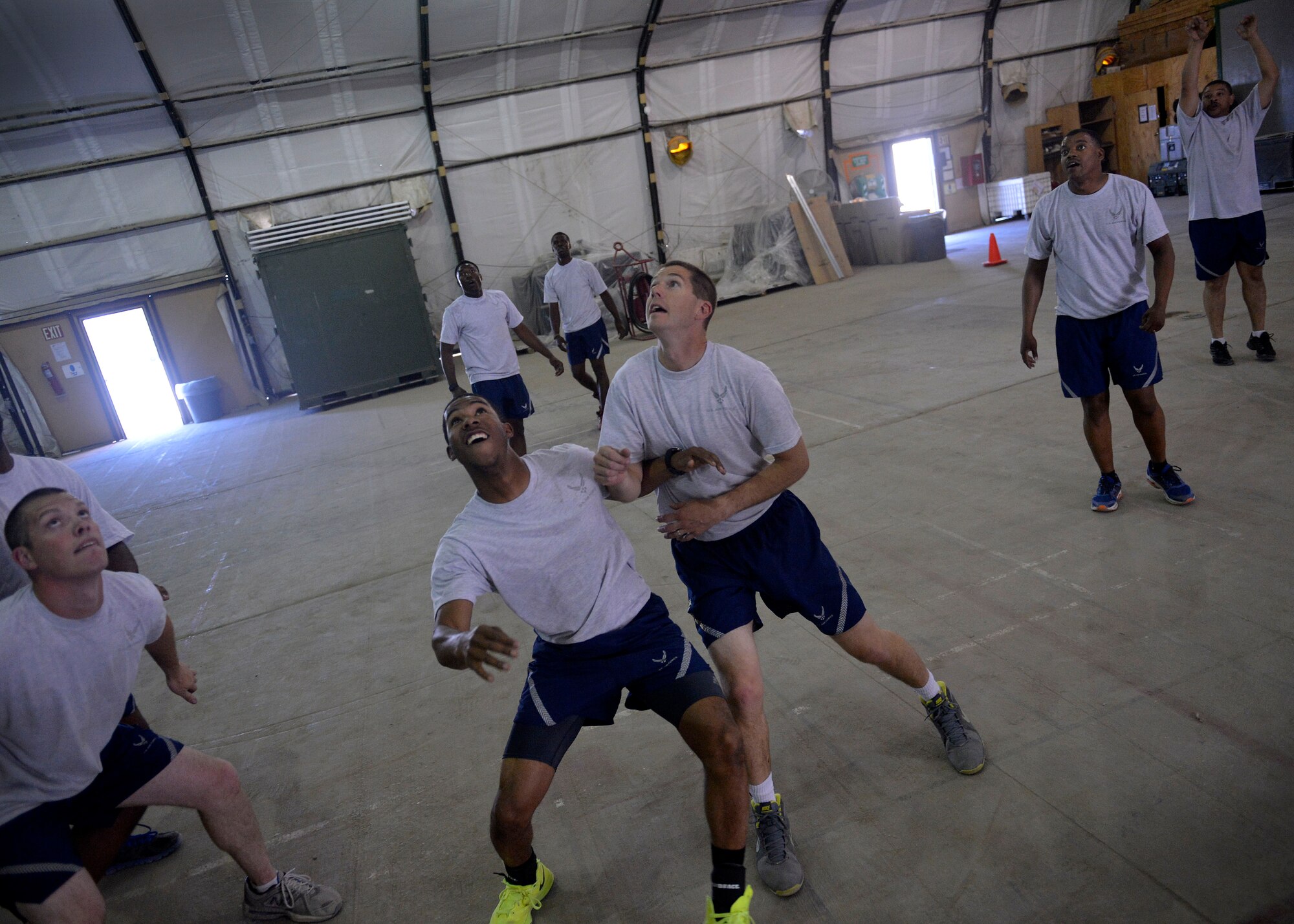 U.S. Air Force Chaplain (Capt.) Lance Schrader, 455th Maintenance Group Chaplain plays a game of basketball with Airmen at Bagram Airfield, Afghanistan June 22, 2014.  Schrader coached men’s and women’s college volleyball for three years and uses some of his coaching skills to help Airmen strengthen their spiritual resiliency.  Schrader is deployed from Mountain Home Air Force Base, Idaho and is a native of Lincoln, Neb.  (U.S. Air Force photo by Staff Sgt. Evelyn Chavez/Released)