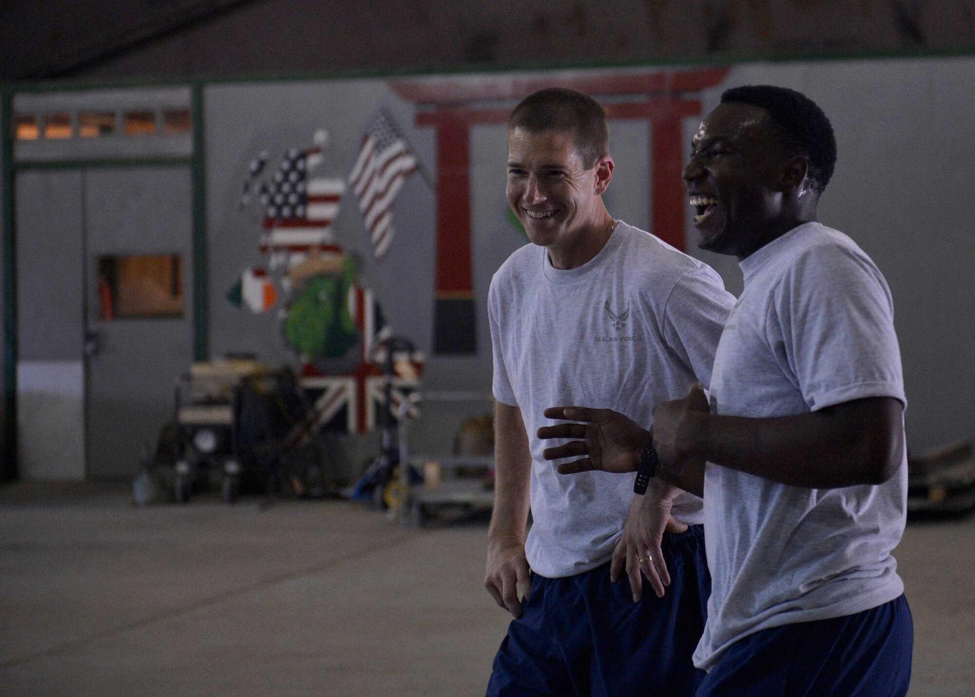 (From left) U.S. Air Force Chaplain (Capt.) Lance Schrader, 455th Maintenance Group Chaplain laughs with Airman 1st Class Darren Beachem, 455th Expeditionary Aircraft Maintenance Squadron,  during a basketball game Bagram Airfield, Afghanistan June 22, 2014.  As the MXG Chaplain, Schrader’s priority is to take care of Airmen and ensure they are spiritually resilient.  Schrader is deployed from Mountain Home Air Force Base, Idaho and is a native of Lincoln, Neb.  (U.S. Air Force photo by Staff Sgt. Evelyn Chavez/Released)