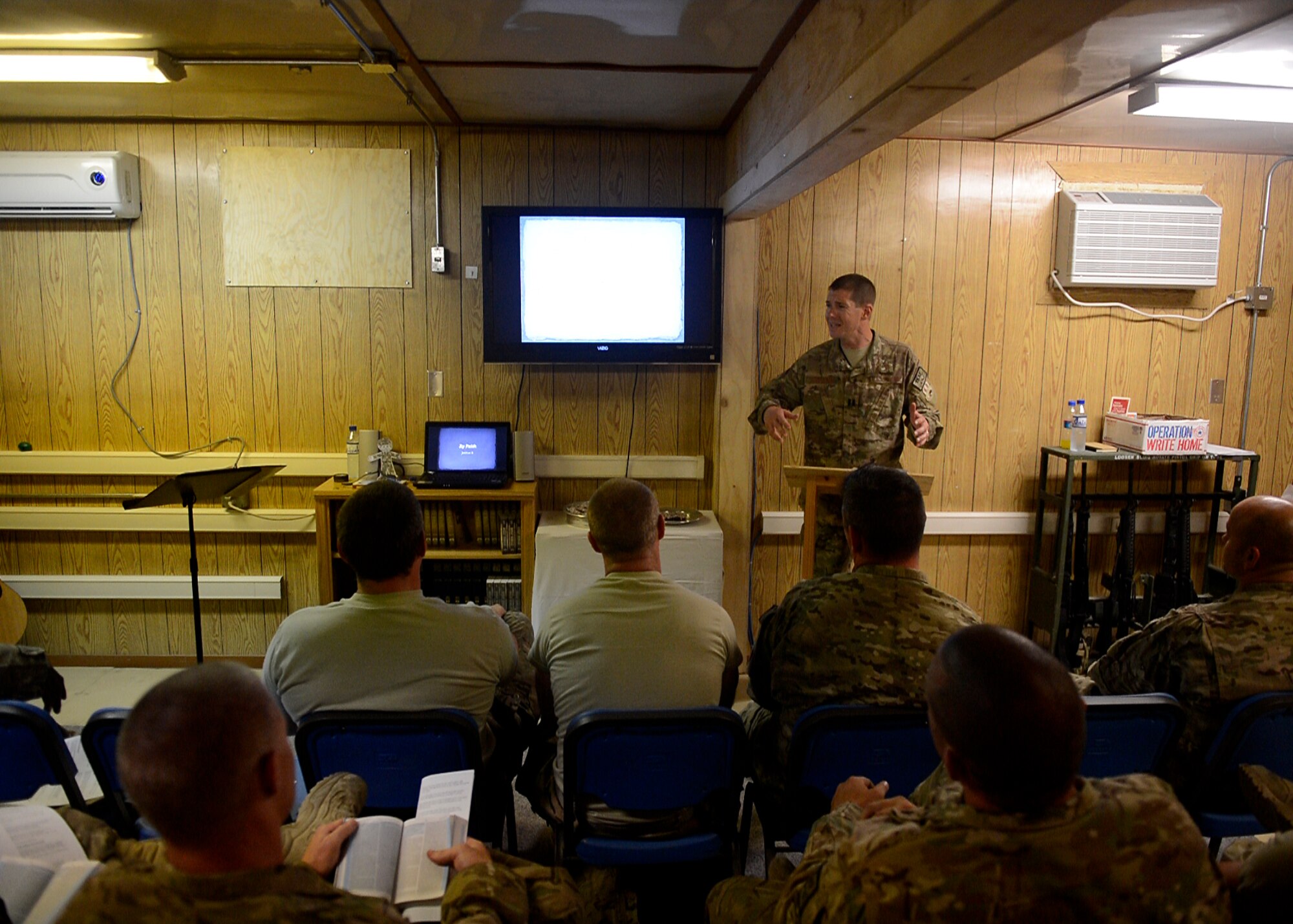 U.S. Air Force Chaplain (Capt.) Lance Schrader, 455th Maintenance Group Chaplain speaks with Airmen during a service at Bagram Airfield, Afghanistan June 22, 2014.  As the MXG Chaplain, Schrader’s priority is to take care of Airmen and ensure they are spiritually resilient.  Schrader is deployed from Mountain Home Air Force Base, Idaho and is a native of Lincoln, Neb.  (U.S. Air Force photo by Staff Sgt. Evelyn Chavez/Released)