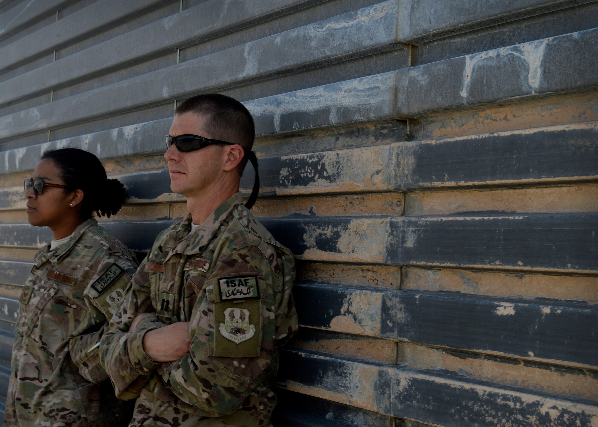 (From left) U.S. Air Force Staff Sgt. Wyleeshia Meekins, 455th Maintenance Group chaplain assistant and Chaplain (Capt.) Lance Schrader, 455th Maintenance Group Chaplain wait for Airmen on the flightline at Bagram Airfield, Afghanistan June 17, 2014.  Meekins and Schrader are one of five Religious Support Teams here; their mission is to help Airmen be spiritually fit to fight.  Schrader is deployed from Mountain Home Air Force Base, Idaho and is a native of Lincoln, Neb.  Meekins is deployed from Keesler Air Force Base, Miss. and a native of Newport News, Va. (U.S. Air Force photo by Staff Sgt. Evelyn Chavez/Released)