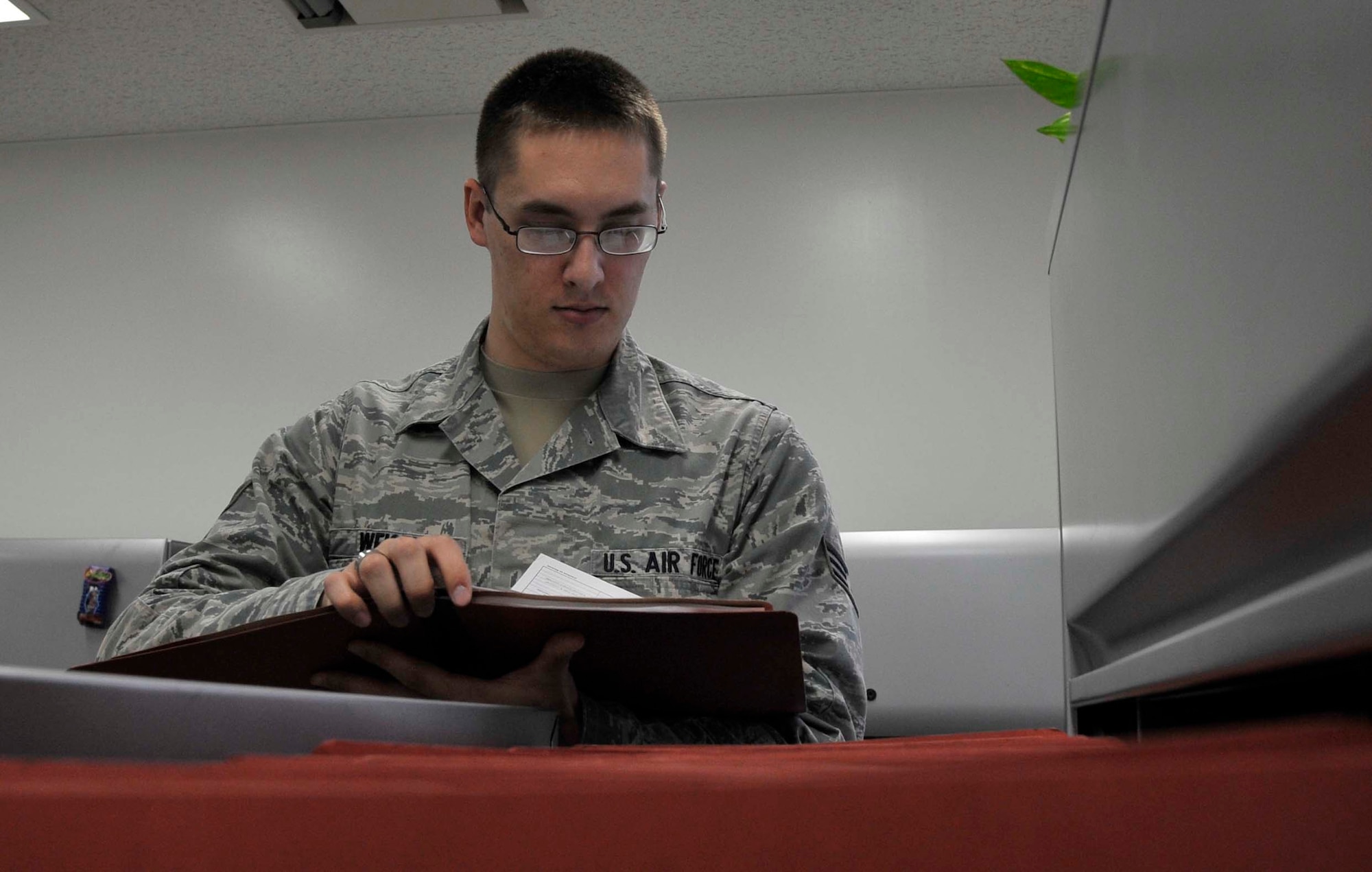 Senior Airman Zachary Weisel, 35th Communications Squadron knowledge management operations base knowledge manager, reviews an evaluation file for military personnel at Misawa Air Base, Japan, June 13, 2014. Weisel provides support to people on base through use of programs like the Enterprise Information Management system and Sharepoint. (U.S. Air Force photo/Airman 1st Class Patrick S. Ciccarone)