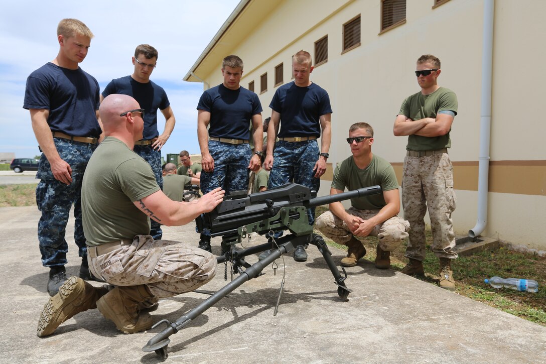 U.S. Naval Academy Midshipmen are shown the functions and intricacies of the MK19 grenade launcher at Moron Air Base, Spain, May 27, 2014. The training was conducted during the midshipmen’s “professional cruise,” a program that allows future Naval Academy graduates to experience time in the Marine Corps.