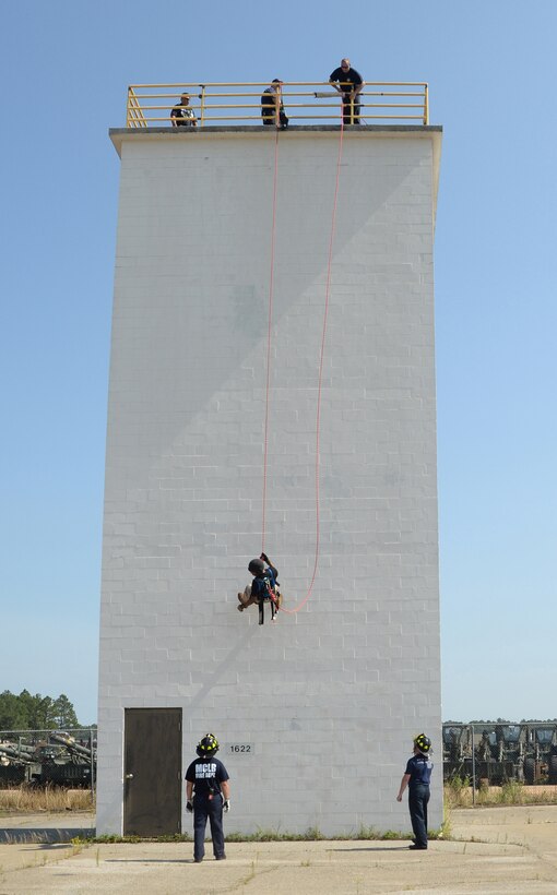 Staff Sgt. Henry Jones, team leader, Special Reaction Team, Marine Corps Police Department, Marine Corps Logistics Base Albany, makes his way down the rappel tower on base as members of Marine Corps Fire Department stand by, June 6.