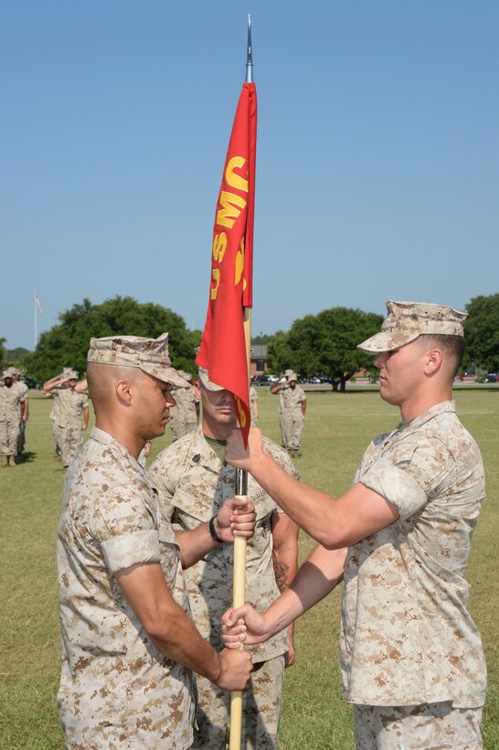 Capt. Kenneth Barber (left) becomes the newest leader of Marine Corps Logistics Base Albany’s Headquarters and Support Company, as he receives the guidon from Capt. Justin Jacobs during the company’s change of command ceremony at Boyett Park, June 19.