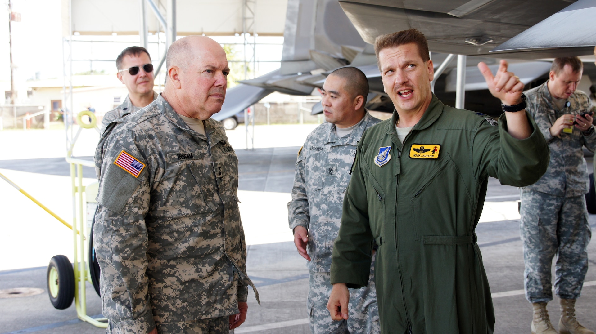 Air Force Lt. Col. Mark Ladtkow, pilot with the 199th Fighter Squadron, briefs Army Lt. Gen. William E. Ingram Jr., Army National Guard director, on the capabilities of Hawaii's Air Guards F-22 Raptor during a tour of National Guard Facilities in Hawaii.