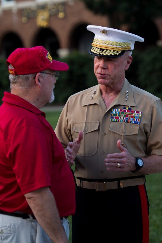 Gen. James F. Amos, commandant of the Marine Corps, speaks with a former U.S. Marine Drum & Bugle Corps member at a concert at Marine Barracks Washington, D.C., June 26, 2014. The concert was to honor the 80th anniversary of the Drum & Bugle Corps. (Official Marine Corps photo by Cpl. Dan Hosack/Released)