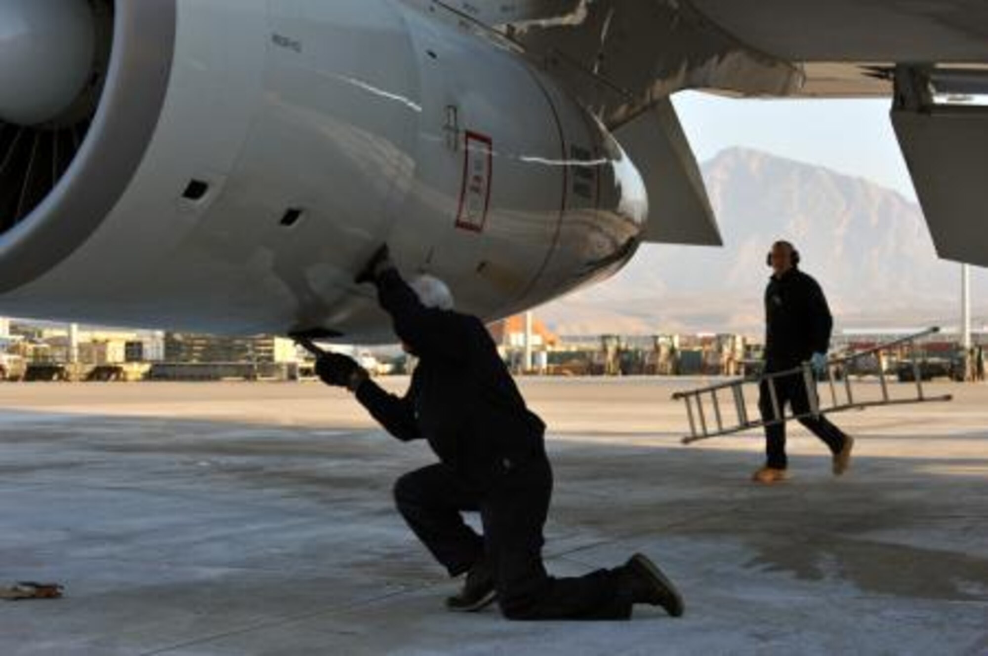 An E-3A aircraft technician works on an engine while deployed to Afghanistan in support of the International Security Assistance Force. (Courtesy photo)