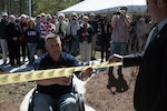 Army Staff Sgt. Scott Millican, who was severely injured in Afghanistan in 2010, cuts the ceremonial ribbon and receives the keys to his new specially adapted home during a ceremony in Statesboro, Ga., March 10, 2012. A crowd of Soldiers and well wishers, including guest speaker Rep. John Barrow of Georgia, celebrated as Millican unlocked his new home. Homes for Our Troops, which fabricated the home, provide specially adapted homes to severely injured veterans at no cost to the veteran.