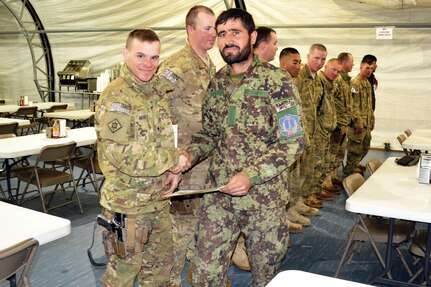 Afghan National Army Sgt. Hasibullah Khudabkhsh (right) and U.S. Army Spc. Bryan Arnold (left), from the 661st Engineer Company, 7th Engineer Battalion, take time for a photo during an awards ceremony, Feb. 6, 2012. The ANA soldiers who received the certificates recently completed the basic horizontal and vertical engineer training with the 7th Engineer Battalion, Task Force Red Devils, from Fort Drum, N.Y.