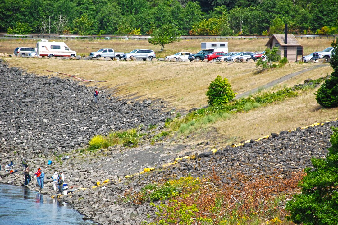 Fishing at the North Shore Recreation Area at Bonneville Lock and Dam; note the yellow painted boundary line on the right. Fishing is not allowed between this line and the dam.