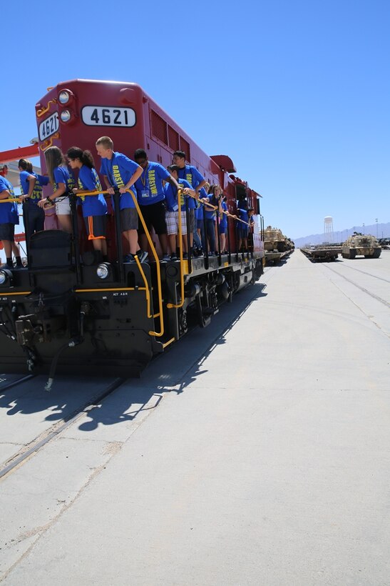 Adolescents from the Barstow Community College Summer Youth Program tour Marine Corps Logistics Base Barstow, Calif., June 19. During their tour, they visited with the Marine Corps Police Department’s K-9 unit here, the base gym, and the rail yard where they learned about different military vehicles and equipment.