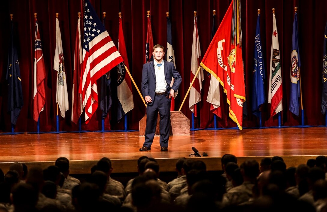 Medal of Honor recipient Cpl. William “Kyle” Carpenter addresses Marines at the base theater aboard Marine Corps Base Camp Pendleton, Calif., June 23, 2014.  During the visit, Carpenter also visited Wounded Warrior Battalion West. Carpenter earned the nation’s highest military award for his actions in Helmand province, Afghanistan, in November 2010. He saved another Marine’s life by shielding him from a grenade blast during an enemy attack.