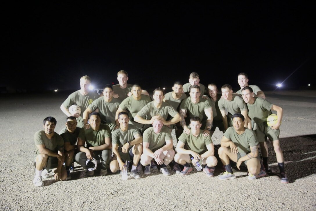 Marines with "Suicide" Charley Company, 1st Battalion, 7th Marine Regiment, pose for a team photo before their first match in the Dwyer World Cup aboard Camp Dwyer, Helmand province, Afghanistan, June 21, 2014. A total of four teams participated in the tournament to include Team America, Afghanistan, Jordan and the World Team (consisting of contractors on the camp). The Marines ultimately defeated the World Team during the final game and were the champions of the tournament. (U.S. Marine Corps photo by Cpl. Joseph Scanlan / released)