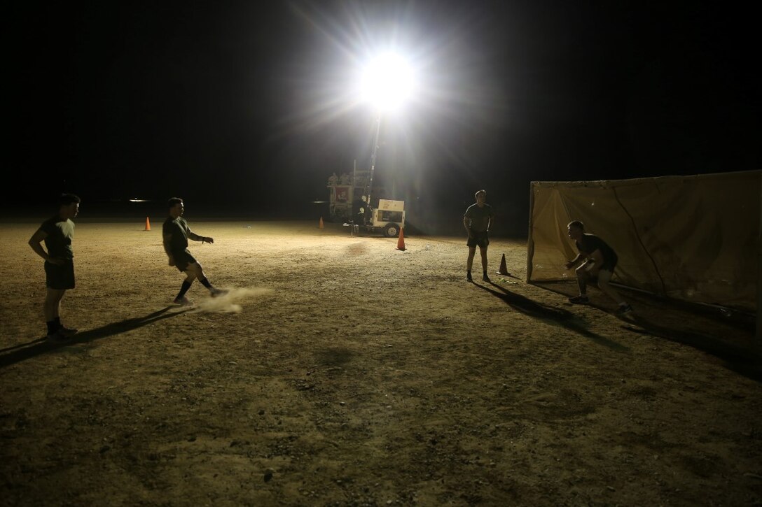 Marines with "Suicide" Charley Company, 1st Battalion, 7th Marine Regiment, conduct shooting drills prior to their first match in the Dwyer World Cup aboard Camp Dwyer, Helmand province, Afghanistan, June 21, 2014. A total of four teams participated in the tournament to include Team America, Afghanistan, Jordan and the World Team (consisting of contractors on the camp). The Marines ultimately defeated the World Team during the final game and were the champions of the tournament.  (U.S. Marine Corps photo by Cpl. Joseph Scanlan / released)