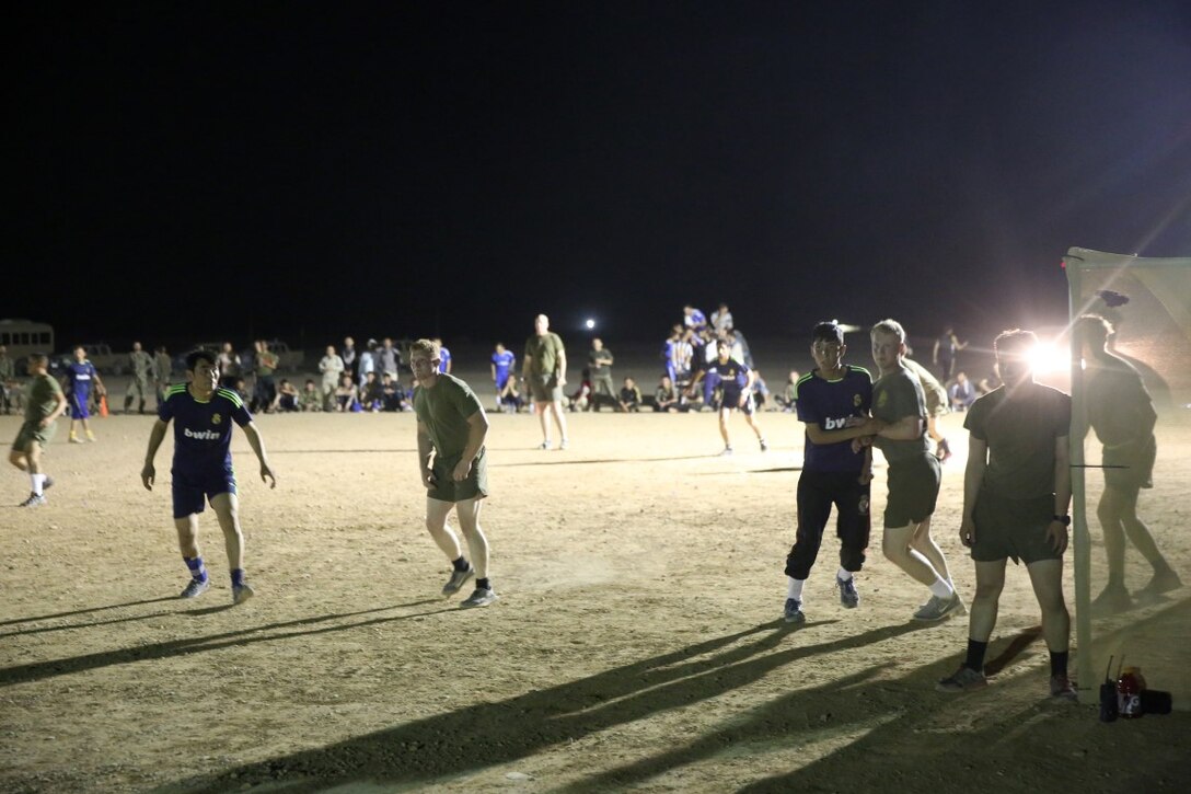 Marines with "Suicide" Charley Company, 1st Battalion, 7th Marine Regiment, defend against Team Afghanistan during their first match in the Dwyer World Cup aboard Camp Dwyer, Helmand province, Afghanistan, June 21, 2014. A total of four teams participated in the tournament to include Team America, Afghanistan, Jordan and the World Team (consisting of contractors on the camp). The Marines ultimately defeated the World Team during the final game and were the champions of the tournament. (U.S. Marine Corps photo by Cpl. Joseph Scanlan / released)