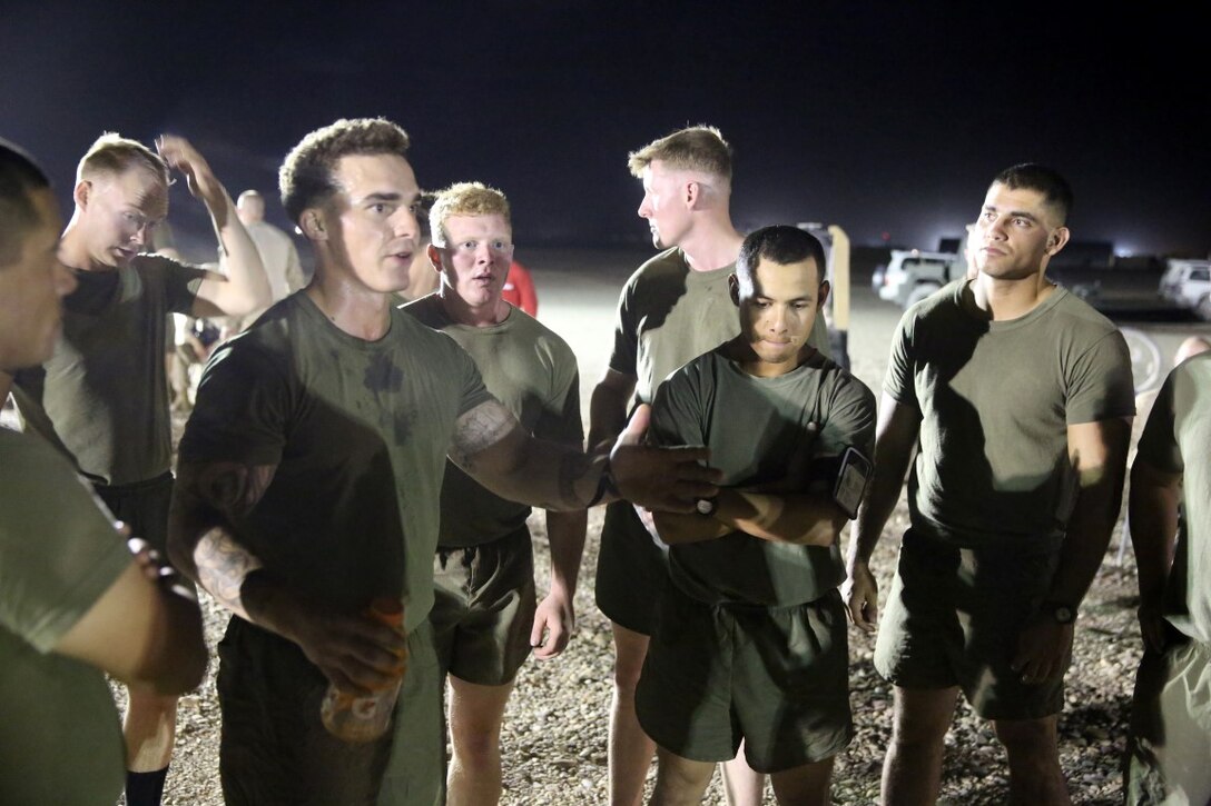 Corporal Ben McCabe, left, fire team leader, "Suicide" Charley Company, 1st Battalion, 7th Marine Regiment, and a native of North Canton, Ohio, speaks to his teammates in a huddle during their first match in the Dwyer World Cup aboard Camp Dwyer, Helmand province, Afghanistan, June 21, 2014. A total of four teams participated in the tournament to include Team America, Afghanistan, Jordan and the World Team (consisting of contractors on the camp). The Marines ultimately defeated the World Team during the final game and were the champions of the tournament. (U.S. Marine Corps photo by Cpl. Joseph Scanlan / released)