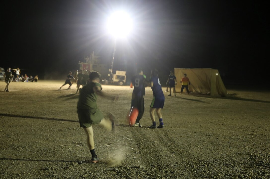 A Marine with "Suicide" Charley Company, 1st Battalion, 7th Marine Regiment, attempts to get a shot on goal during the team's first match in the Dwyer World Cup aboard Camp Dwyer, Helmand province, Afghanistan, June 21, 2014. A total of four teams participated in the tournament to include Team America, Afghanistan, Jordan and the World Team (consisting of contractors on the camp). The Marines ultimately defeated the World Team during the final game and were the champions of the tournament. (U.S. Marine Corps photo by Cpl. Joseph Scanlan / released)