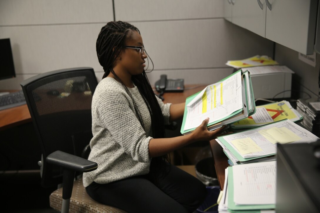Girl filing doc: Taneshi Noel, student clerk at Marine Corps Logistics Base Barstow’s Human Resource Office, files documents, June 23. New summer hires here are gaining on the job experience for future careers. 