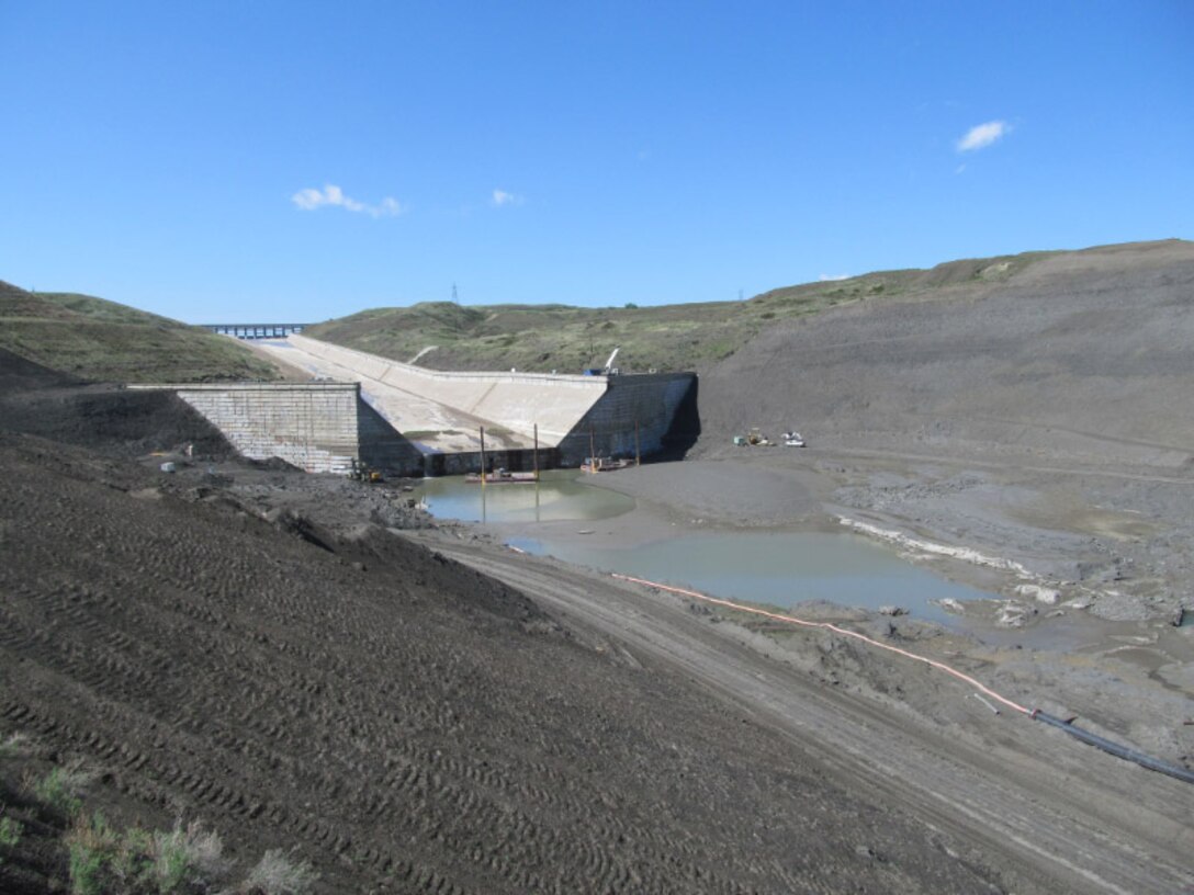 Bottom of the Fort Peck spillway. Contractors are working on the plunge pool at the end of the spillway installing horizontal anchors in the downstream concrete wall.