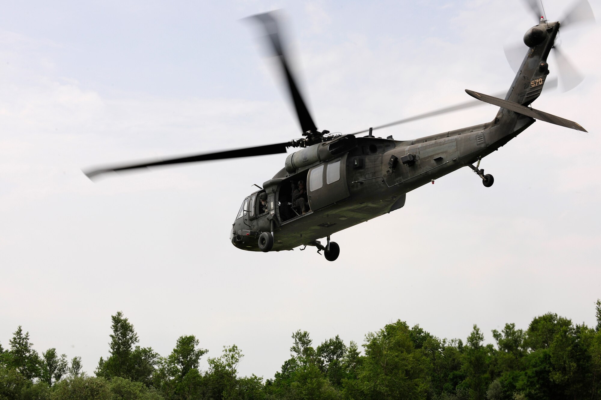 A UH-60 Black Hawk helicopter approaches the landing zone during a combat search and rescue training mission, June 24, 2014, at Cellina Meduna training ground near Maniago, Italy. Establishing a good relationship with other branches of the U.S. military helps mitigate risk and confusion in the event of a real-world situation requiring military intervention and assistance. (U.S. Air Force photo/Airman 1st Class Ryan Conroy)
