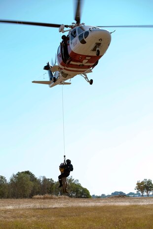 A Sikorsky S-76 search-and-rescue helicopter lowers medical personnel during a SAR training exercise onto Royal Australian Air Force Base Tindal, Australia, during Exercise Southern Frontier 2014, June 11. Southern Frontier is an annual bilateral training exercise between the RAAF and the United States Marine Corps with a primary focus on offensive air support and enhancing military interoperability.  
