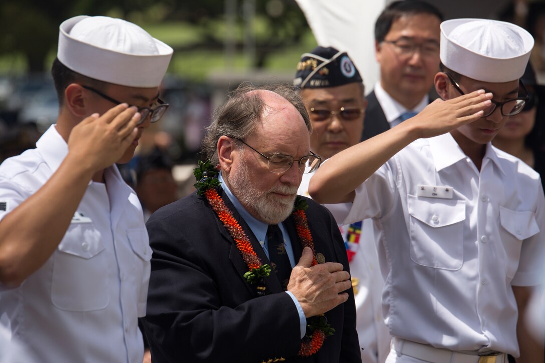 Hawaii governor Neil Abercrombie (center) places his hand on his heart as two Republic of Korea Navy cadets salute after laying a wreath at the base of the National Memorial Cemetery of the Pacific (Punchbowl) during the 64th annual Korean War memorial ceremony, June 25, 2014. The ceremony commemorated U.S. and Republic of Korea veterans, both living and dead, who fought for the freedom of South Korea, and guests in attendance laid wreaths at the base of the memorial to honor those who gave their lives. (U.S. Marine Corps photo by Cpl. Matthew J. Bragg)