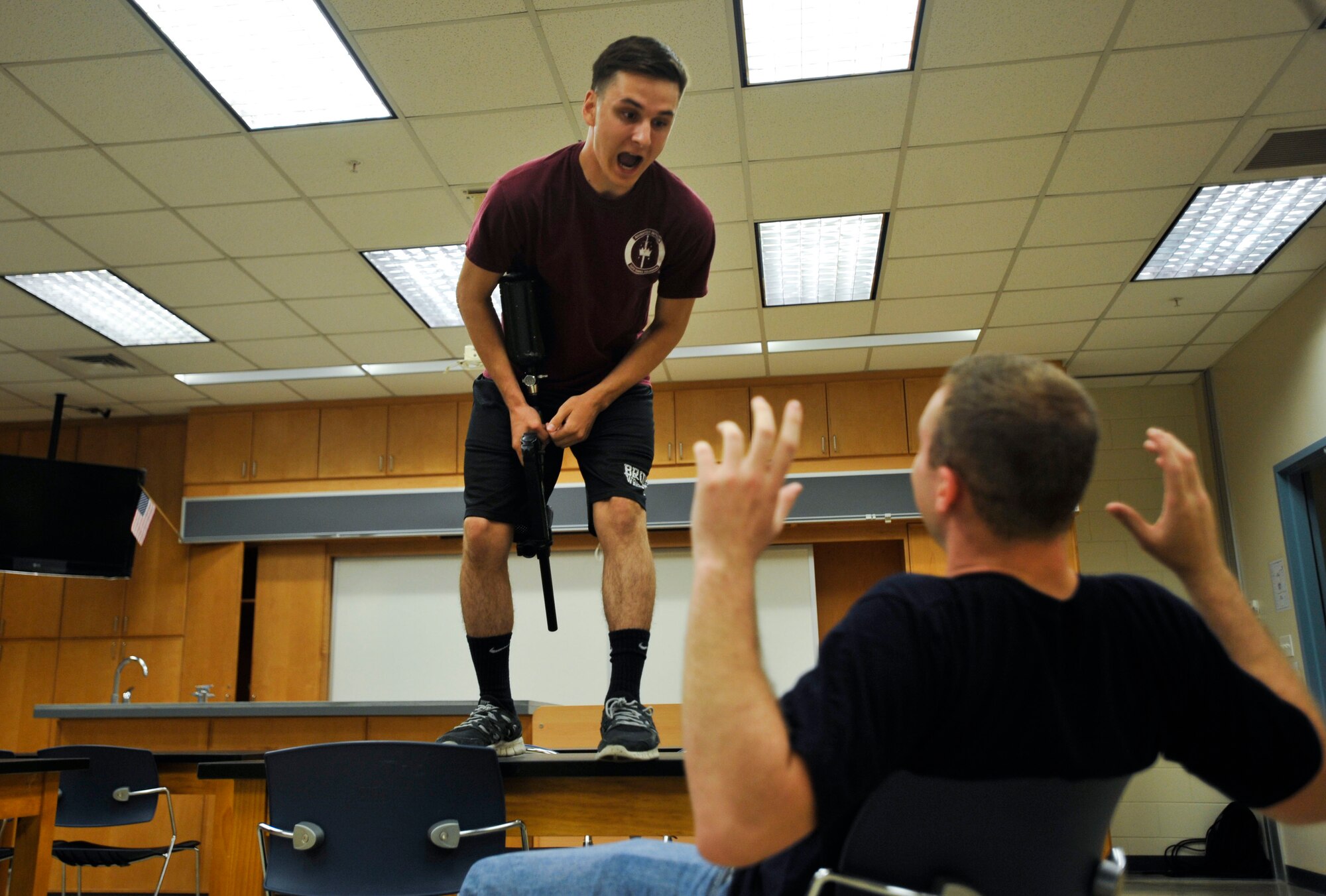 Airman Benjamin Baker, left, 51st Logistic Readiness Squadron Transportation Management Office packing and crating apprentice, simulates taunting Senior Airman Brandon Busch, 51st LRS TMO cargo apprentice, during an active shooter exercise as part of a combat readiness course on Osan Air Base, Republic of Korea, June 18, 2014. Airmen from the 51st Security Forces Squadron learned about different active shooter scenarios during the classroom portion of the training. (U.S. Air Force photo/Senior Airman David Owsianka)