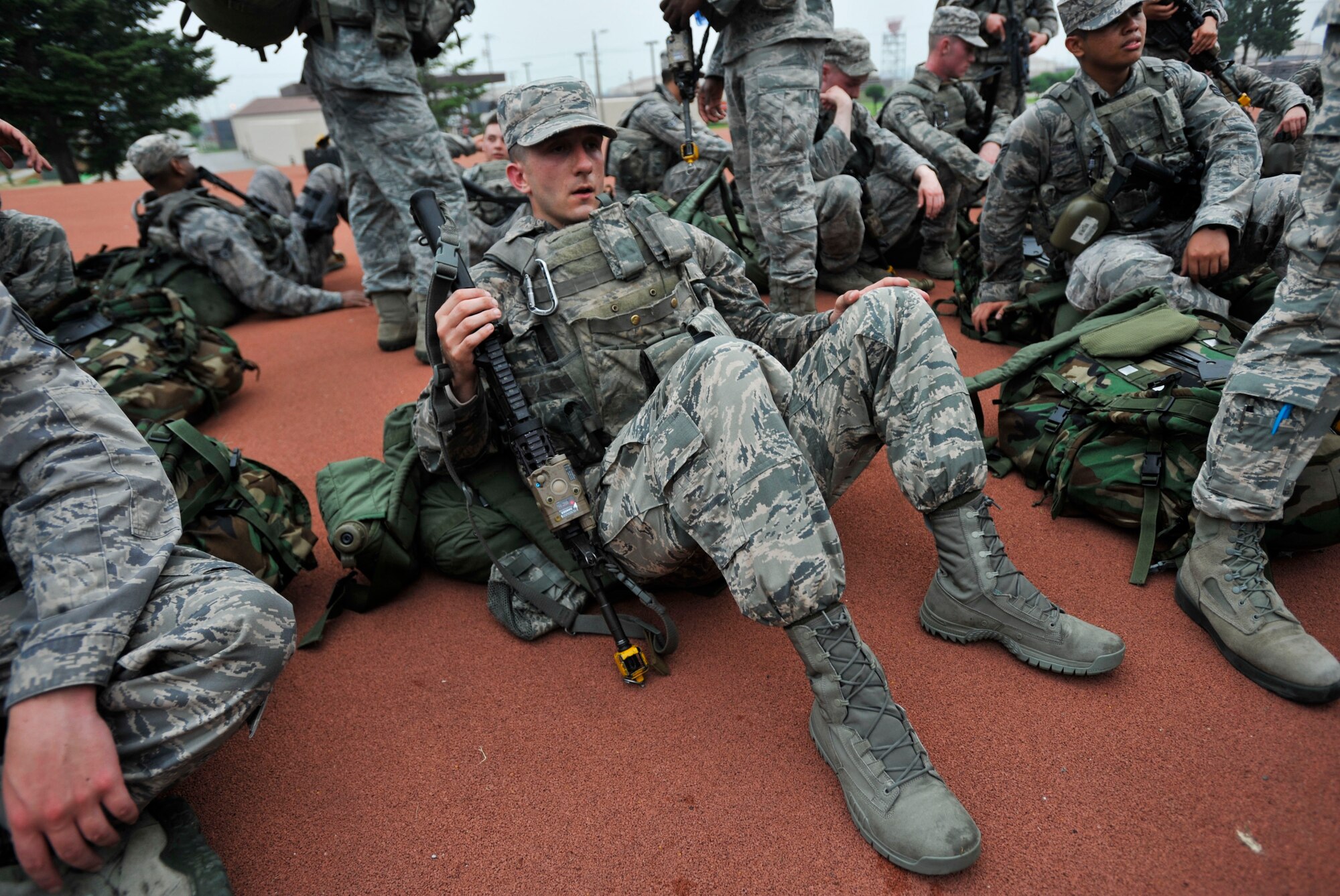 A member of the 51st Security Forces Squadron lays down on the fitness center’s physical training pad after finishing the ruck march portion of a combat readiness course on Osan Air Base, Republic of Korea, June 17, 2014. The march lasted for approximately 3 hours. (U.S. Air Force photo/Senior Airman David Owsianka)