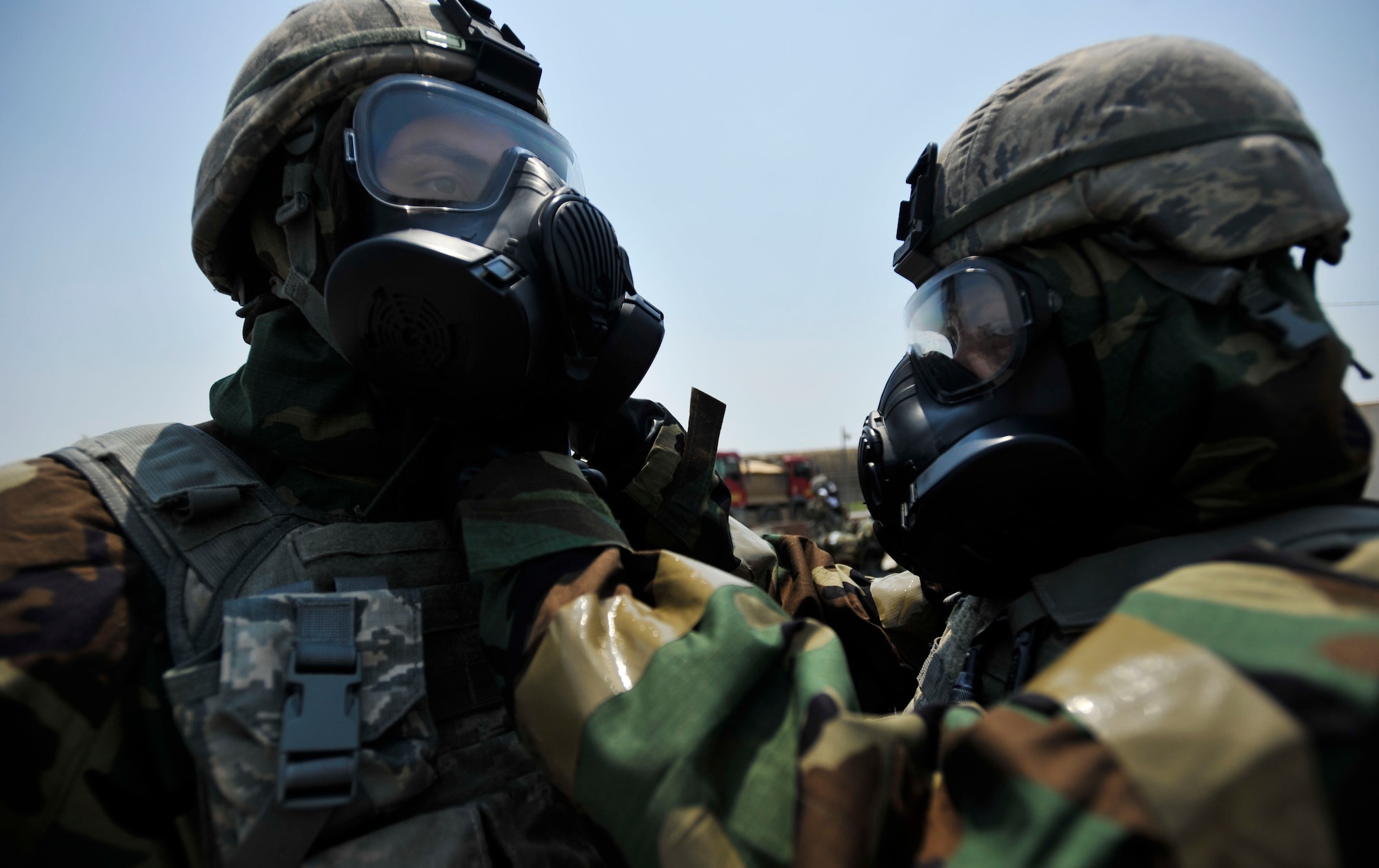 Airmen 1st Class Alexis Dinger and William Kant, 51st Security Forces Squadron members, perform a buddy check during the ability to survive and operate training portion of a combat readiness course on Osan Air Base, Republic of Korea, June 16, 2014. This portion of the course teaches Airmen about the chemical war fare side of fighting. (U.S. Air Force photo/Senior Airman David Owsianka)