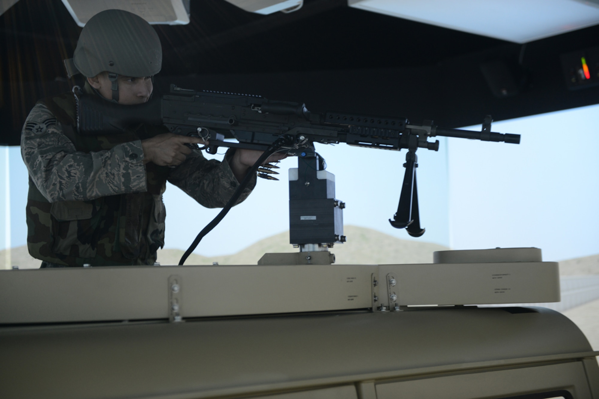 Senior Airman Jonathan Buenrostro, 673d Contracting Squadron contract specialist, operates a High Mobility Multipurpose Wheeled Vehicle mounted turret  during the Reconfigurable Vehicle Tactical Trainer program on Joint Base Elmendorf-Richardson, Alaska, June 18, 2014. The RVTT provides individual digital mission command network training and system skills to commanders and staff. (U.S. Air Force photo/Airman 1st Class Ty-Rico Lea)