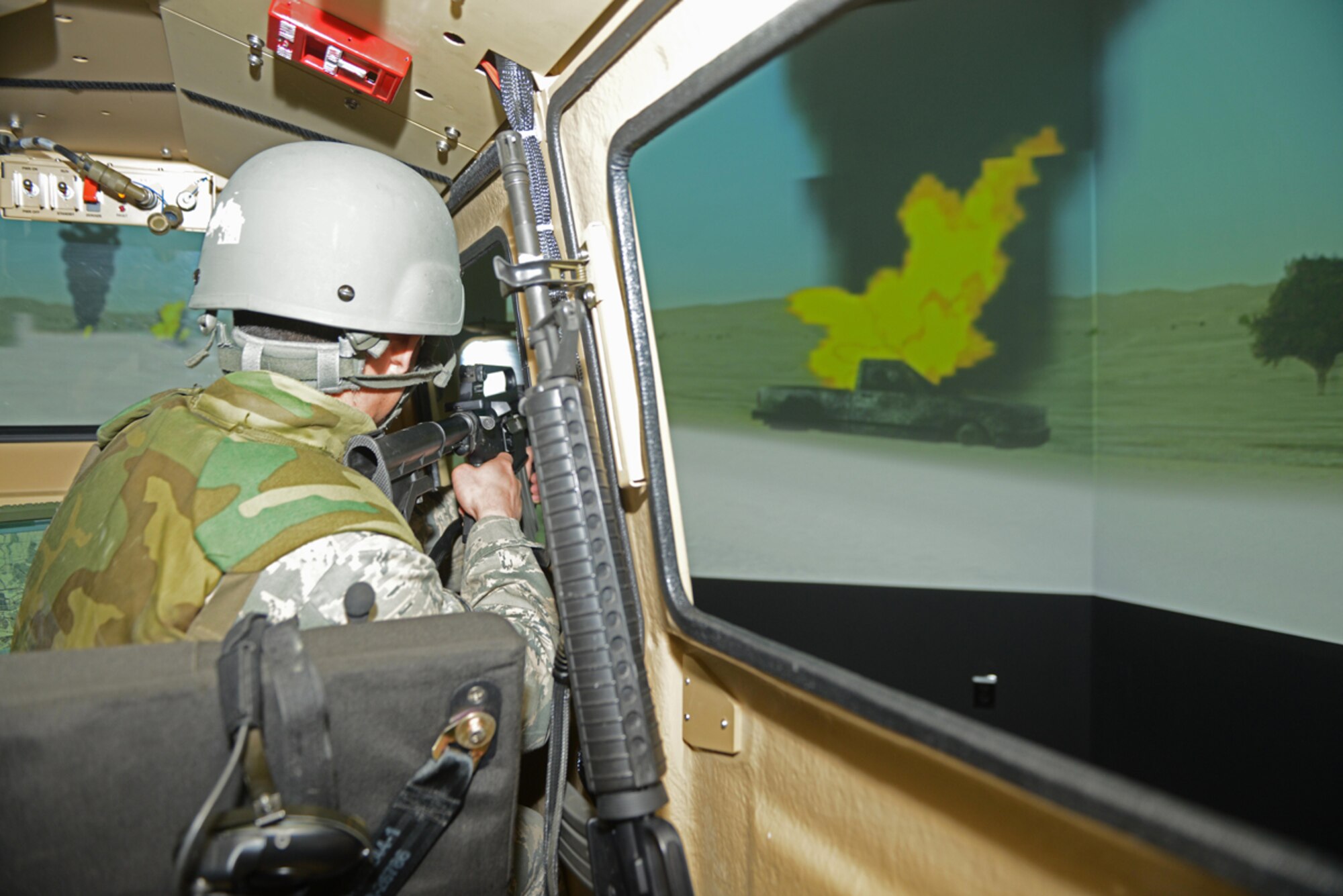 Senior Airman Aaron Thomas, 673d Contracting Squadron contract specialist maintains a sector of fire during the Reconfigurable Vehicle Tactical Trainer program on Joint Base Elmendorf-Richardson, Alaska, June 18, 2014. The RVTT program and simulator are provided to service members from all branches. (U.S. Air Force photo/Airman 1st Class Ty-Rico Lea)