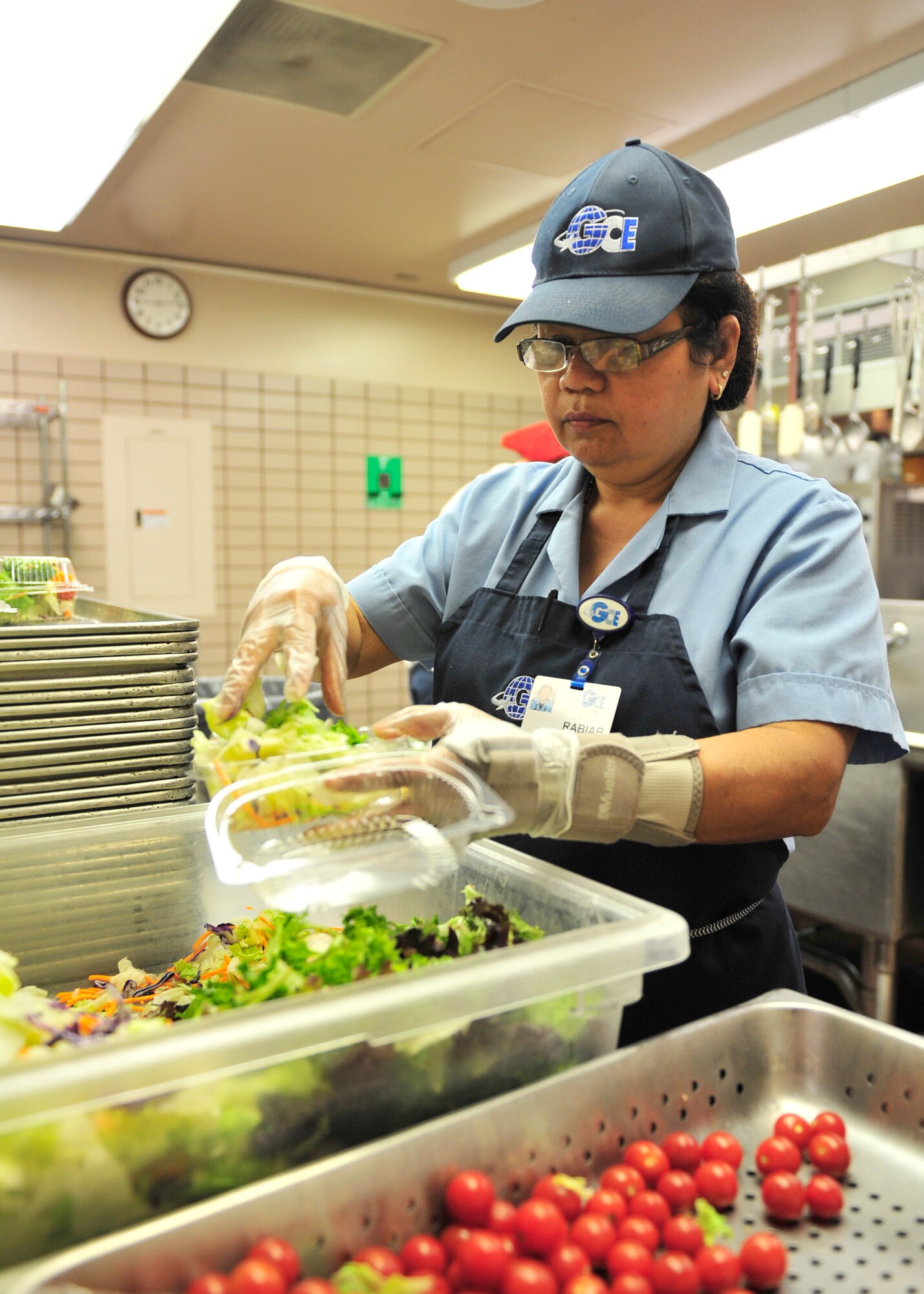 Rabiab Gabow, 354th Force Support Squadron contracted cook, prepares salads prior to the lunch rush during RED FLAG-Alaska 14-2 at the Two Seasons Dining Facility June 23, 2013, Eielson Air Force Base, Alaska. Gadow makes anywhere between 500 to 1,000 salads daily for military members from other bases and countries during RF-A. (U.S. Air Force photo by Senior Airman Ashley Nicole Taylor/Released)