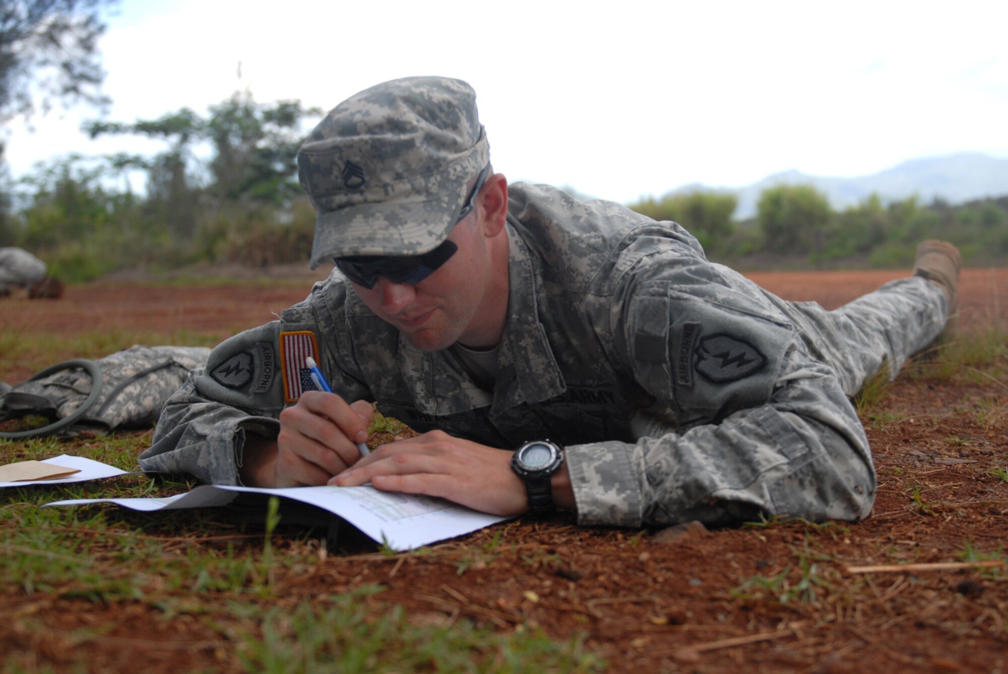 Army Staff Sgt. Adam White, a scout team leader with Headquarters and Headquarters Company, 1st Battalion (Airborne), 501st Infantry Regiment, plots grid coordinates during the land navigation portion of the 2014 United States Army Pacific Command’s Best Warrior Challenge. White went on to win and be named the 2014 USARPAC NCO of the Year. (U.S. Army photo/Spc. David Innes)