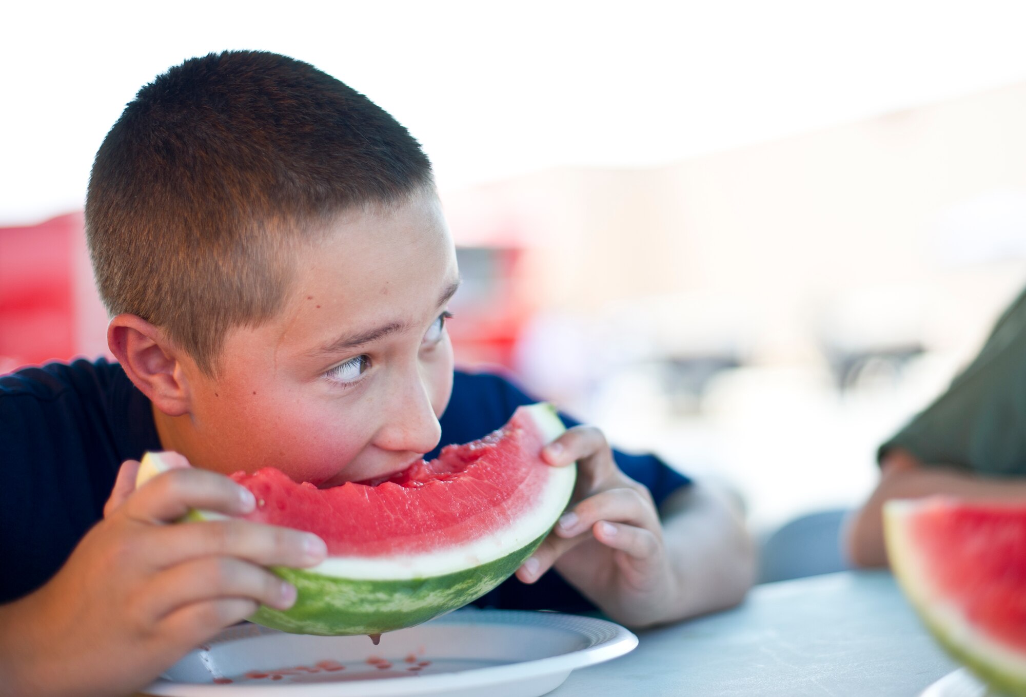 A child at Holloman Air Force Base N.M., participates in a watermelon eating contest  June 26, 2014 during a commissary-hosted event to promote healthy living.  The program is meant to emphasize healthy eating, and highlight different physical activities that are good for overall well-being. (U.S. Air Force photo by Staff Sgt Stacy Moless/Released)