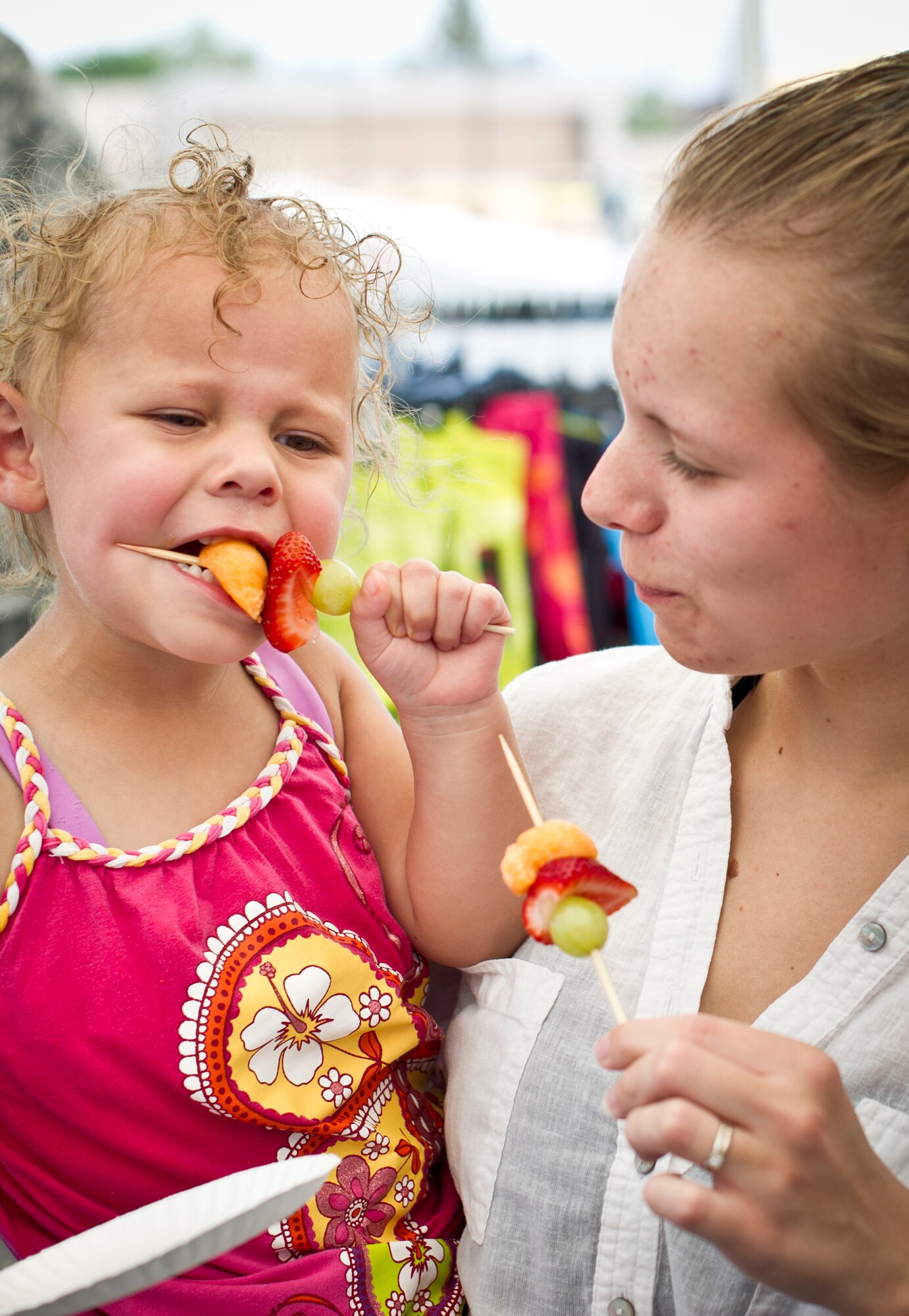 Members of the Cox family enjoy a fruit kabob at Holloman Air Force Base N.M.,  June 26, 2014 during a commissary-hosted event to promote healthy living.  The program is meant to emphasize healthy eating, and highlight different physical activities that are good for overall well-being. (U.S. Air Force photo by Staff Sgt Stacy Moless/Released)