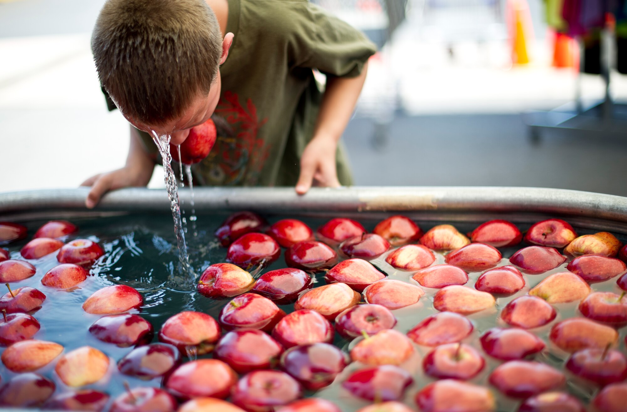 A child at Holloman Air Force Base N.M., bobs for apples  June 26, 2014 during a commissary-hosted event to promote healthy living.  The program is meant to emphasize healthy eating, and highlight different physical activities that are good for overall well-being. (U.S. Air Force photo by Staff Sgt Stacy Moless/Released)