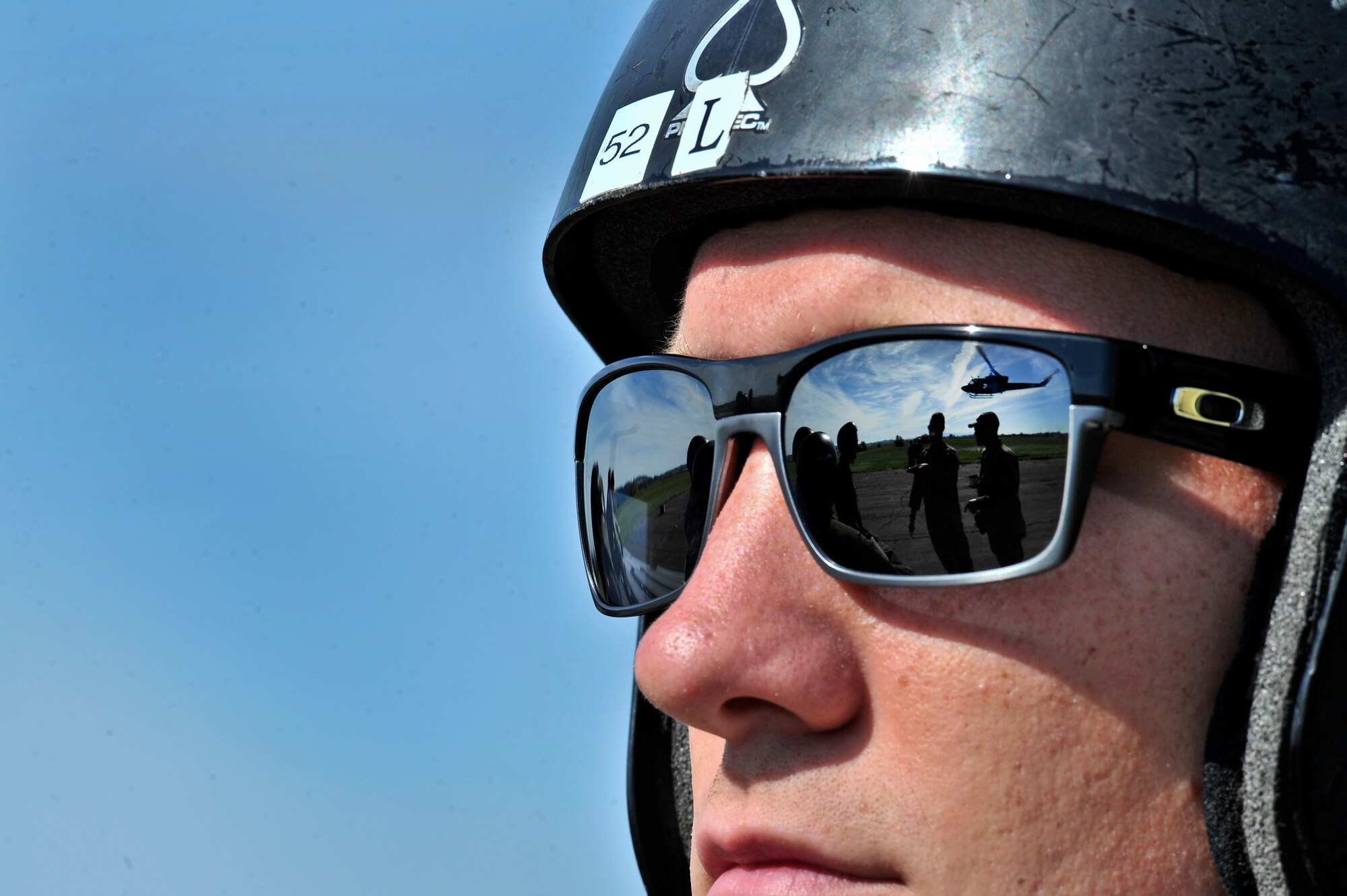 A students from the Survival, Evasion, Resistance and Escape school waits to approach the UH-1N Iroquois helicopter during hoist training at Fairchild Air Force Base, Washington, June 25, 2014.  The SV-80B course gives students an opportunity to experience firsthand how to safely be hoisted into a helicopter. (U.S. Air Force photo by Staff Sgt. Alexandre Montes/Released)