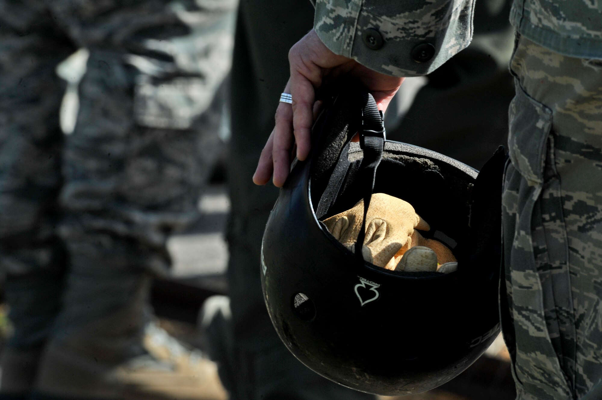 A student from the Survival, Evasion, Resistance and Escape School waits to approach the UH-1N Iroquois helicopter during hoist training at Fairchild Air Force Base, Washington, June 25, 2014.  The SV-80B course gives students an opportunity to experience firsthand how to safely be hoisted into a helicopter. (U.S. Air Force photo by Staff Sgt. Alexandre Montes/Released)