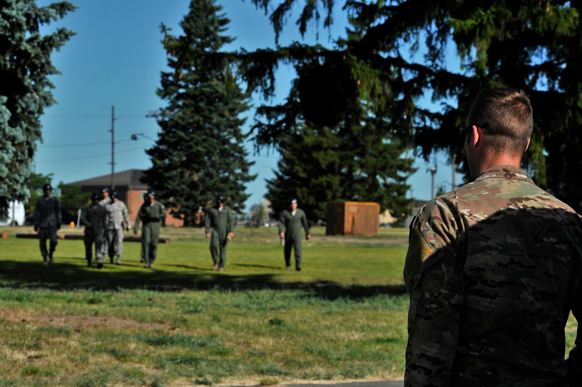 Airman 1st Class Jacob Furbeck waits for SV-80B students to begin their UH-1N Iroquois helicopter hoist training at Fairchild Air Force Base, Washington, June 25, 2014. Furbeck is a Survival, Evasion, Resistance and Escape specialist who instructs a portion of the SV-80B course that gives students an opportunity to experience firsthand how to safely be hoisted into a helicopter. Flight crews assigned to the 36th Rescue Flight assist students attending the 17-day school by providing airlift for training and in the event of an accident.  (U.S. Air Force photo by Staff Sgt. Alexandre Montes/Released)