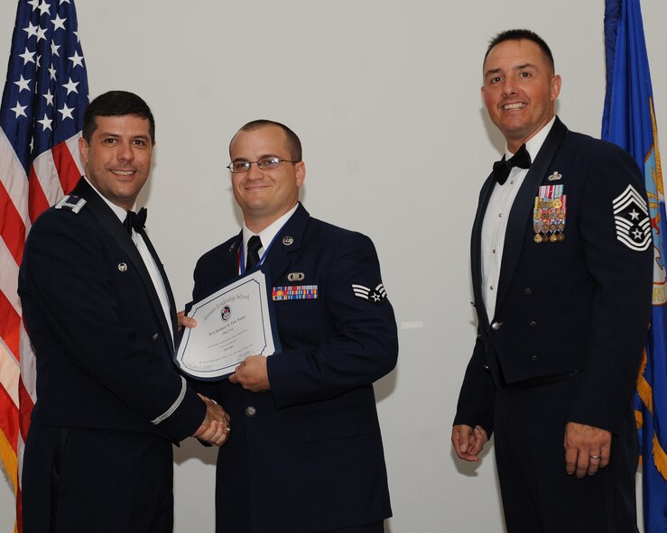 Senior Airman Zachary Van Natta, 608th Air Operations Center, receives an Airman Leadership School graduation certificate from Col. Andrew Gebara, 2nd Bomb Wing commander, during the ALS Class 14-5 Graduation on Barksdale Air Force Base, La., June 19, 2014. (U.S. Air Force photo/Senior Airman Benjamin Gonsier)