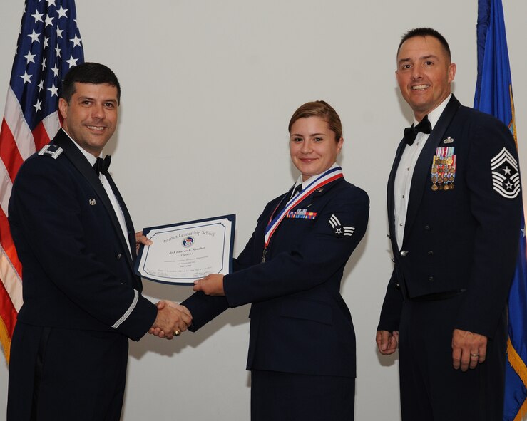 Senior Airman Lauren Spacher, 2nd Medical Support Squadron, receives an Airman Leadership School graduation certificate from Col. Andrew Gebara, 2nd Bomb Wing commander, during the ALS Class 14-5 Graduation on Barksdale Air Force Base, La., June 19, 2014. (U.S. Air Force photo/Senior Airman Benjamin Gonsier)