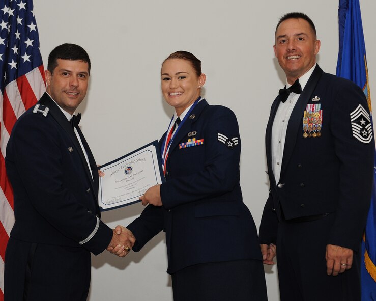 Senior Airman Amber Rodriguez, 2nd Operations Support Squadron, receives an Airman Leadership School graduation certificate from Col. Andrew Gebara, 2nd Bomb Wing commander, during the ALS Class 14-5 Graduation on Barksdale Air Force Base, La., June 19, 2014. (U.S. Air Force photo/Senior Airman Benjamin Gonsier)