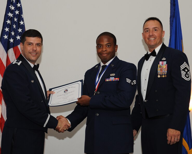 Senior Airman Danny Riddlespriger, 2nd Bomb Wing Judge Advocates Office, receives an Airman Leadership School graduation certificate from Col. Andrew Gebara, 2nd BW commander, during the ALS Class 14-5 Graduation on Barksdale Air Force Base, La., June 19, 2014. (U.S. Air Force photo/Senior Airman Benjamin Gonsier)