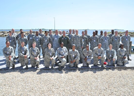 Colonel Mark O’Laughlin, 325th Fighter Wing vice commander, (Center) and Chief Master Sgt. Christopher Lantagne, 325th FW command chief, (Center) pose for a group photo with some of Tyndall’s most recent technical sergeant promotees at the Base Marina June 26. The Air Force selected 6,684 of 38,344 eligible staff sergeants for promotion to technical sergeant for a selection rate of 17.43 percent. Of those selected, 76 promotees are Team Tyndall members. (U.S. Air Force photo by Airman 1st Class Sergio Gamboa) 